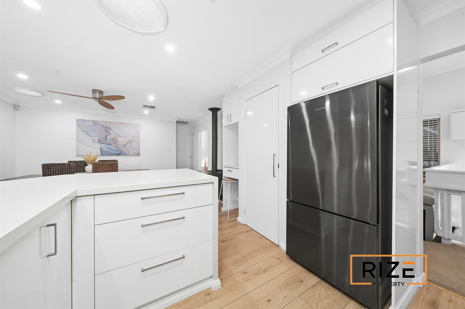 Kitchen storage and the potbelly fireplace beyond